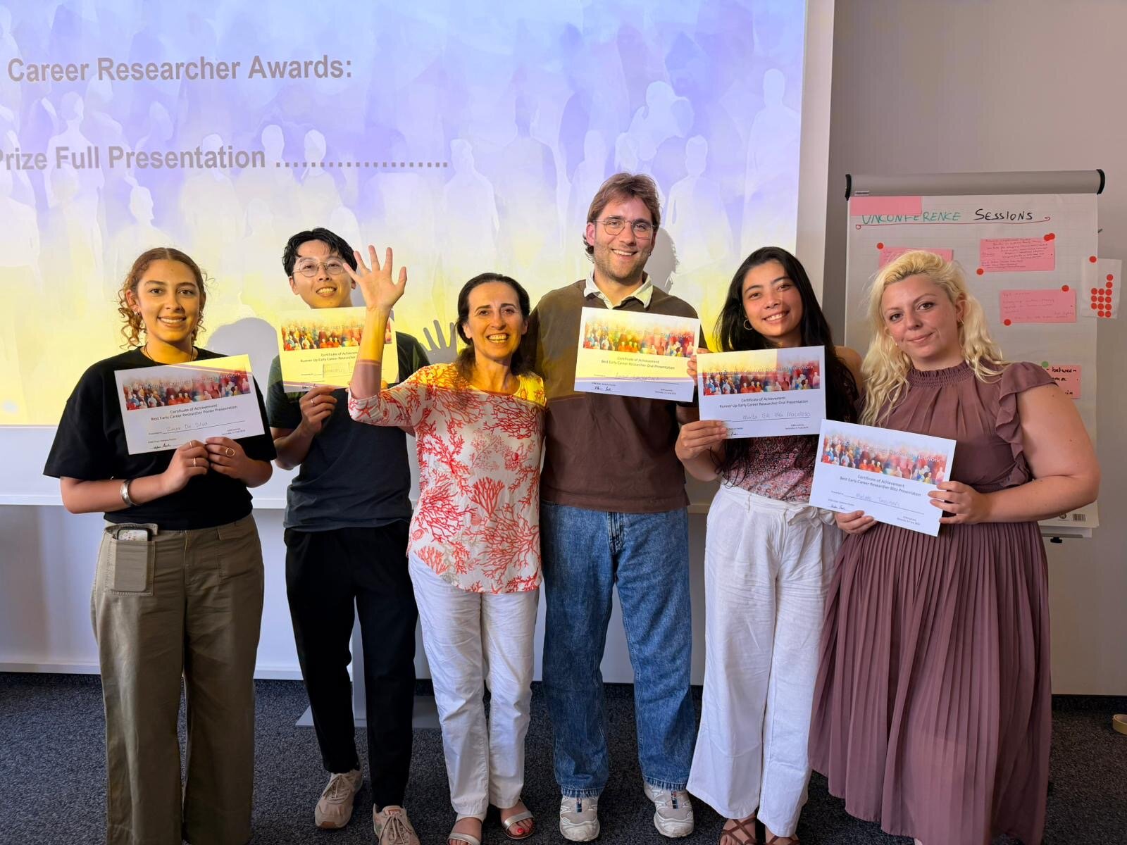 Summit attendees holding certificates